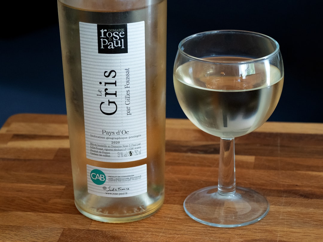 A bottle of wine and a glass of it.