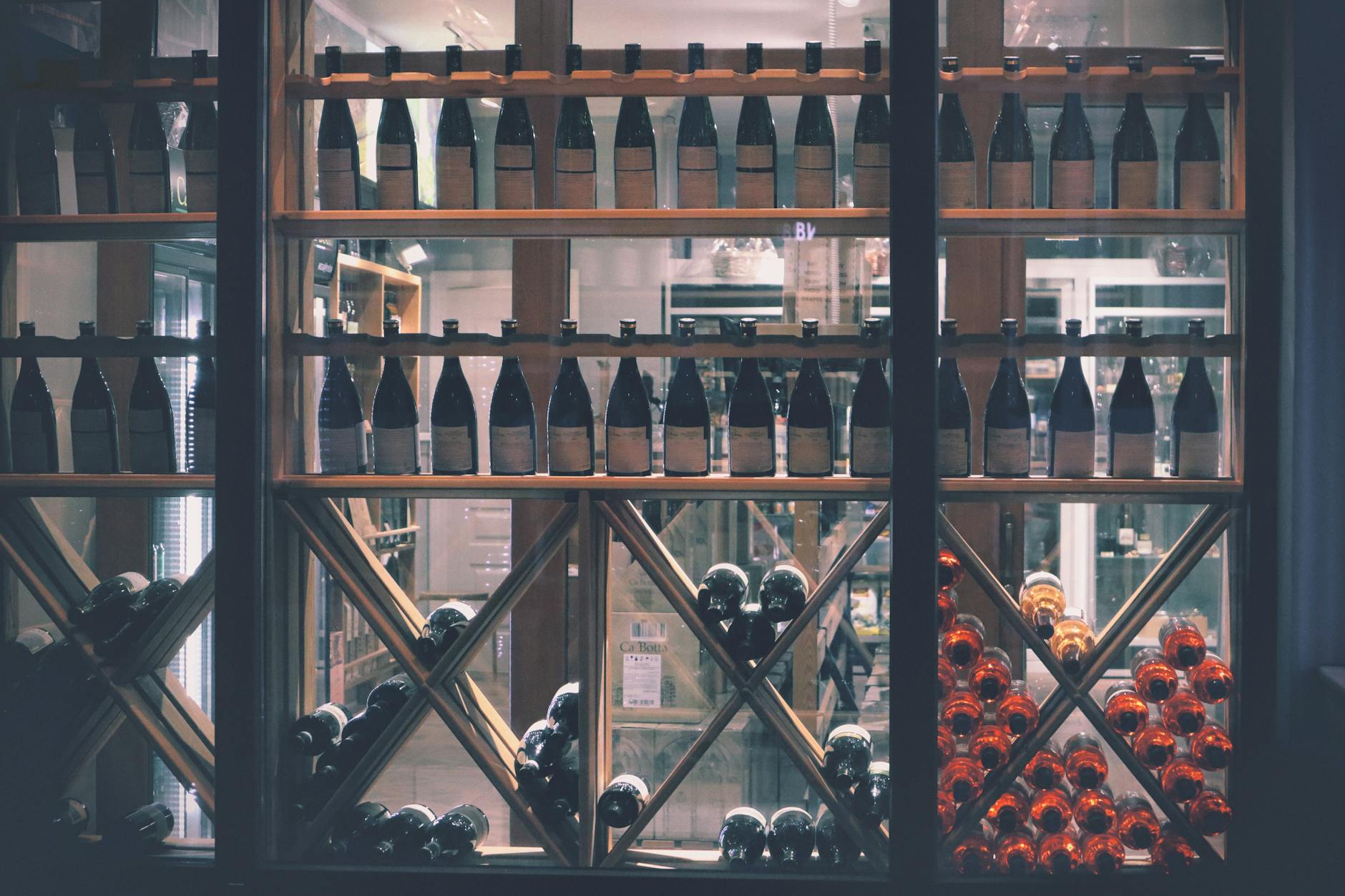 A beautifully arranged wine display in a market setting, featuring diverse bottles.