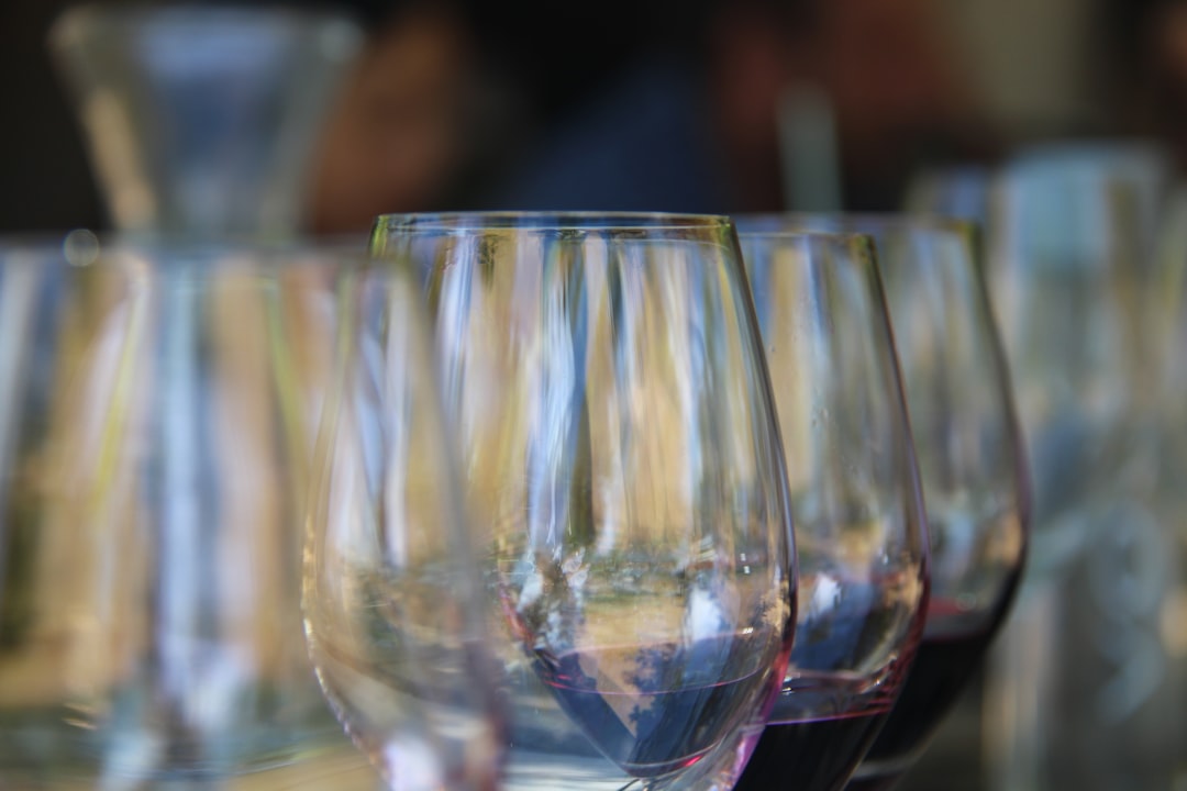 a row of wine glasses sitting on top of a table