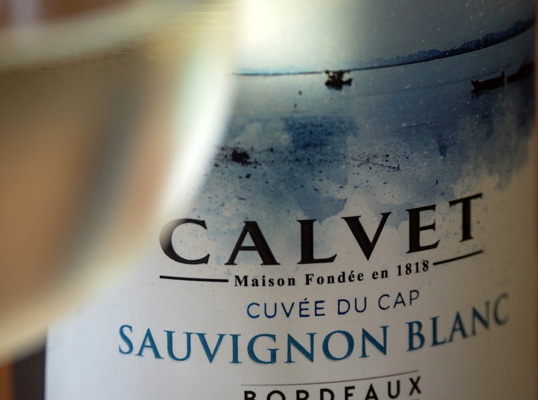A close up of a bottle of wine and a glass